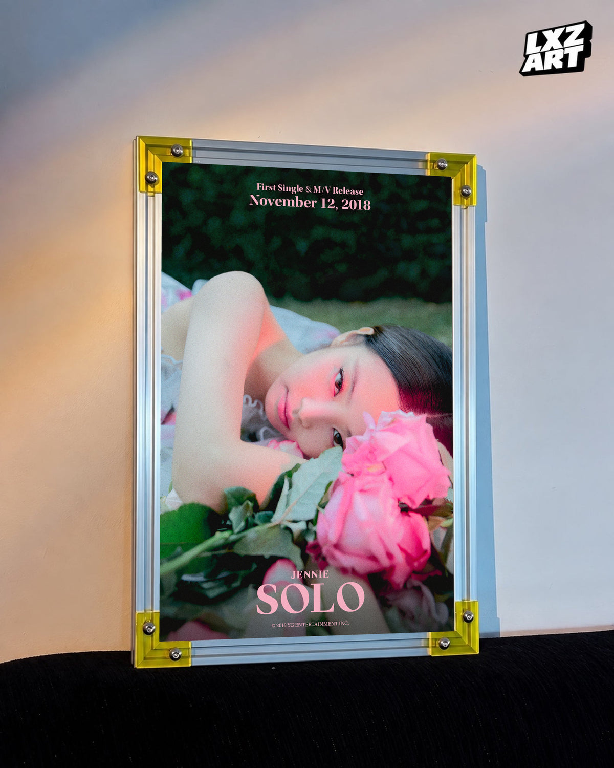 JENNIE SOLO pink rose teaser poster displayed against a warm wall in a yellow-corner frame; unframed print, frame not included