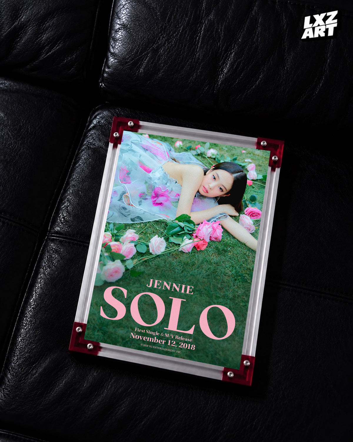 JENNIE SOLO garden teaser poster displayed on a black leather sofa in a red-corner frame; unframed print, frame not included