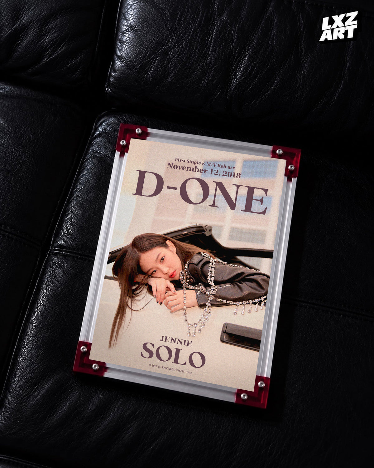 JENNIE SOLO d-one car poster displayed on a black leather sofa in a red-corner frame; unframed print, frame not included