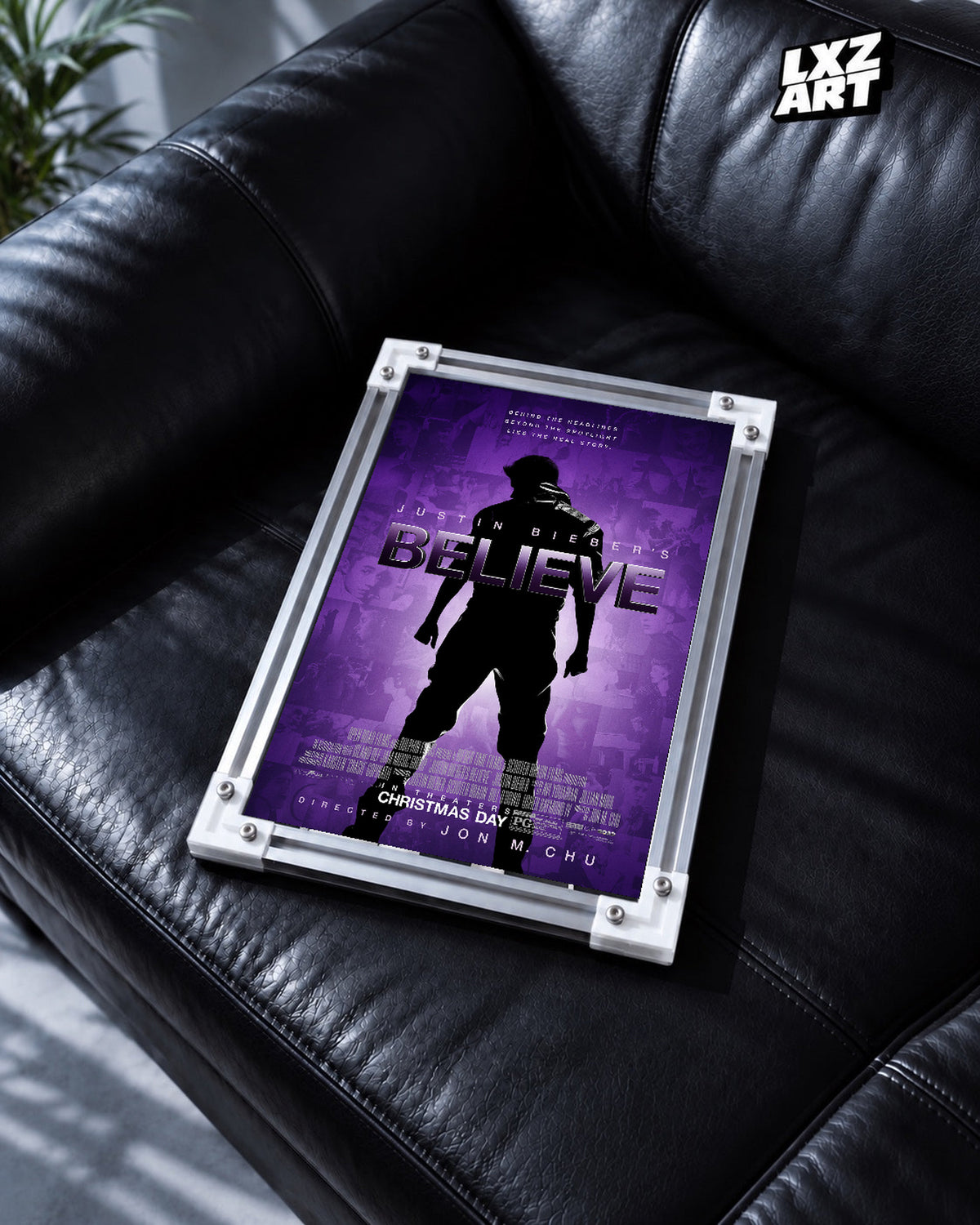 Justin Bieber Believe Purple Silhouette Concert Film Poster displayed in a white-corner frame on a black leather sofa. Frame for display only.