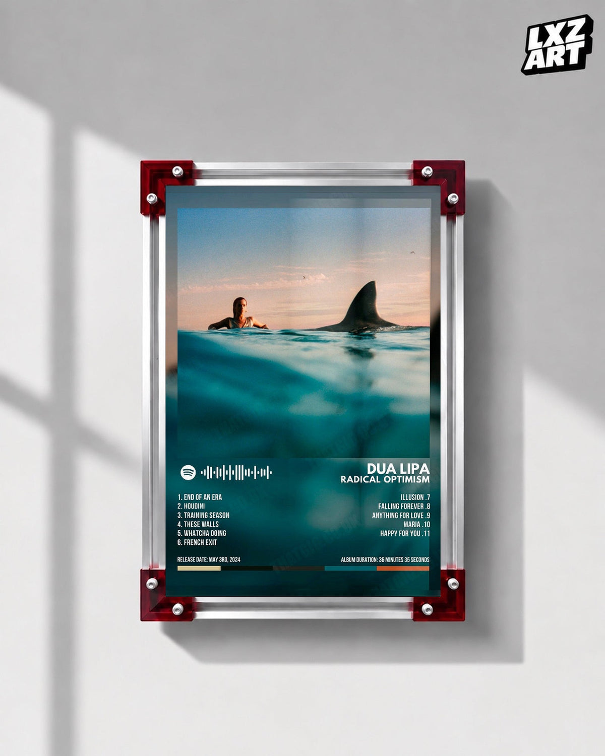 Dua Lipa Radical Optimism Ocean Tracklist Poster displayed on a gray wall in a red corner frame; unframed print, frame not included