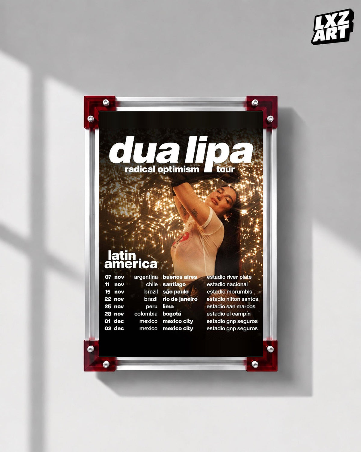 Dua Lipa Radical Optimism Latin America Tour Poster displayed on a gray wall in a red corner frame; unframed print, frame not included
