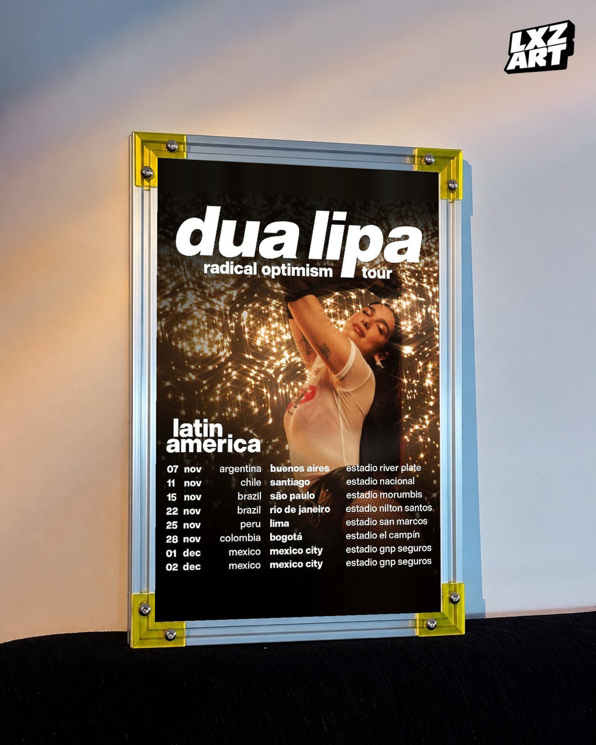 Dua Lipa Radical Optimism Latin America Tour Poster displayed on a warm wall in a yellow corner frame; unframed print, frame not included