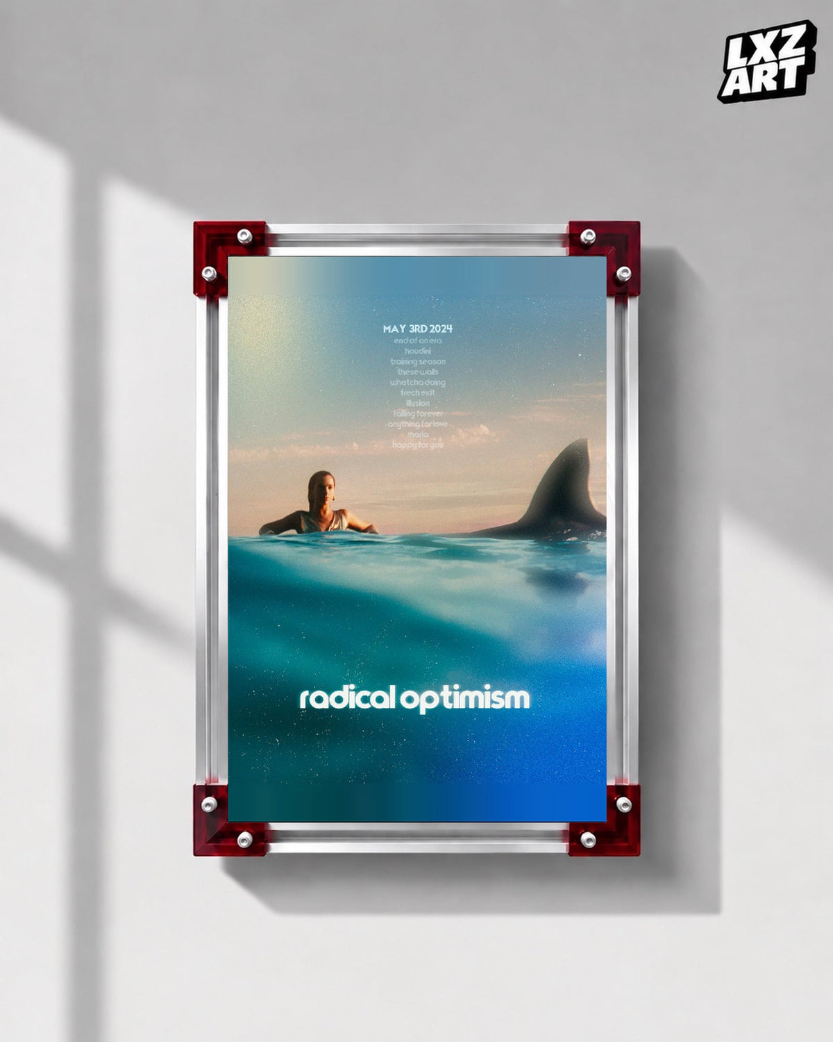 Dua Lipa Radical Optimism Ocean Typography Poster displayed on a gray wall in a red corner frame; unframed print, frame not included