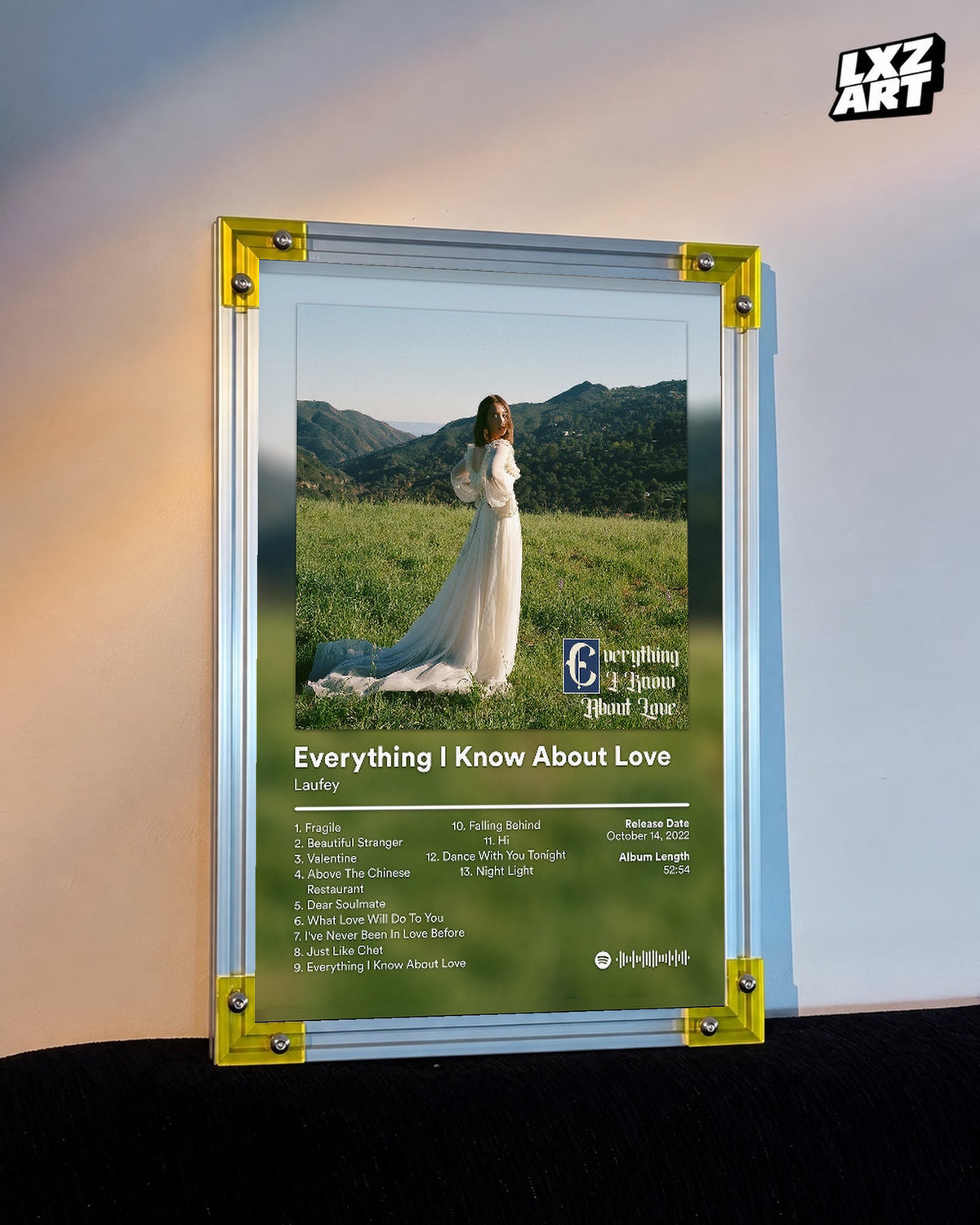 Laufey Everything I Know About Love Meadow Tracklist Poster displayed on a warm wall in a yellow corner frame; unframed print, frame not included
