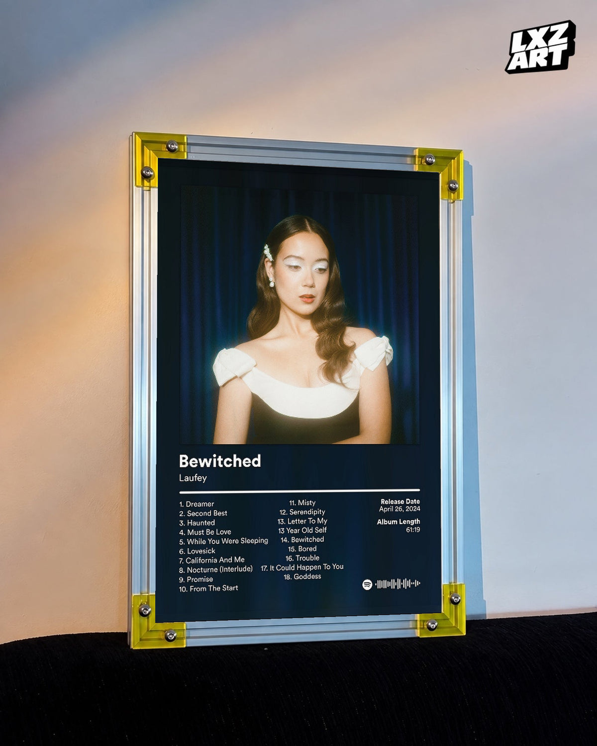 Laufey Bewitched Goddess Edition Blue Curtain Tracklist Poster displayed on a warm wall in a yellow corner frame; unframed print, frame not included