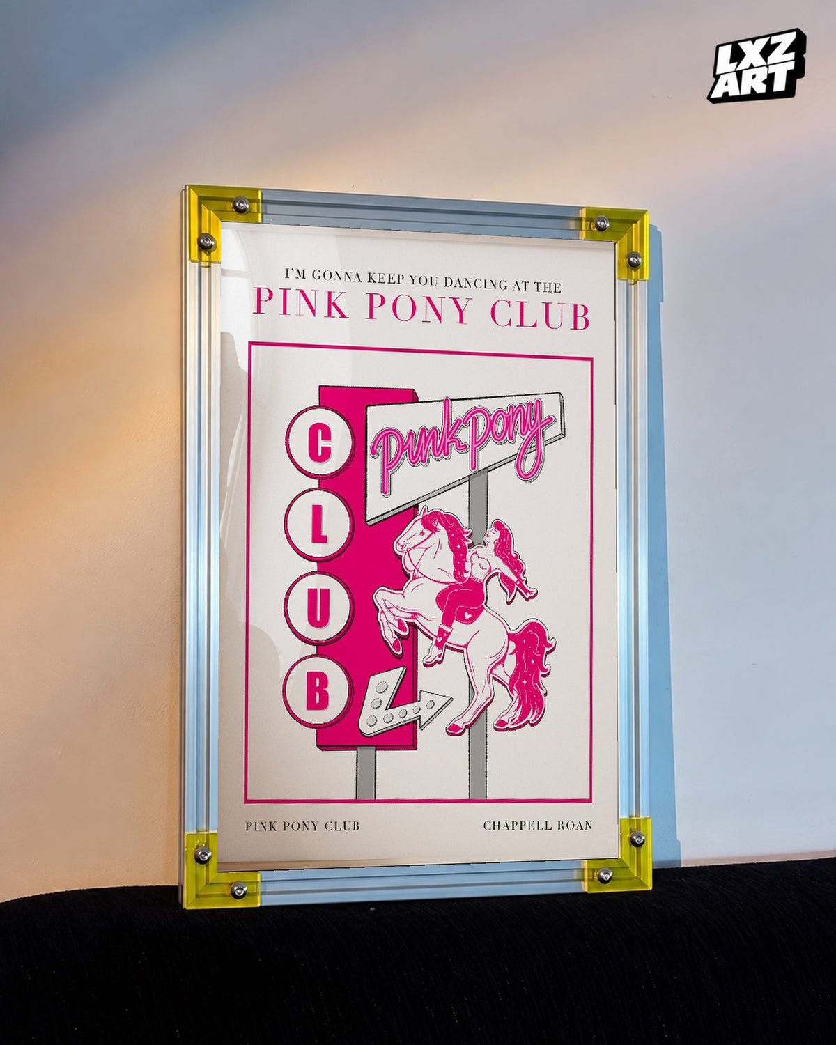 Chappell Roan Pink Pony Club Pink Sign Illustration Poster displayed on a warm wall in a yellow corner frame; unframed print, frame not included