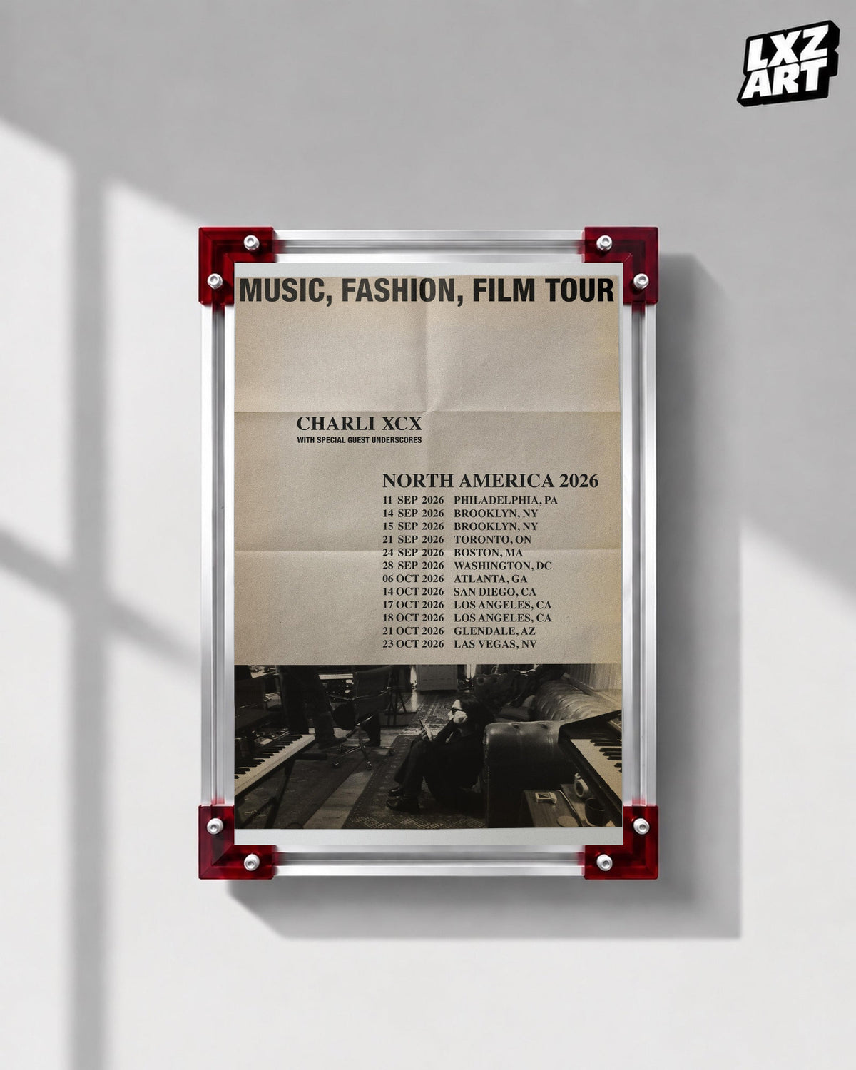 Charli xcx Music Fashion Film 2026 Tour Poster with the complete tour heading displayed on a gray wall in a red corner frame; frame not included