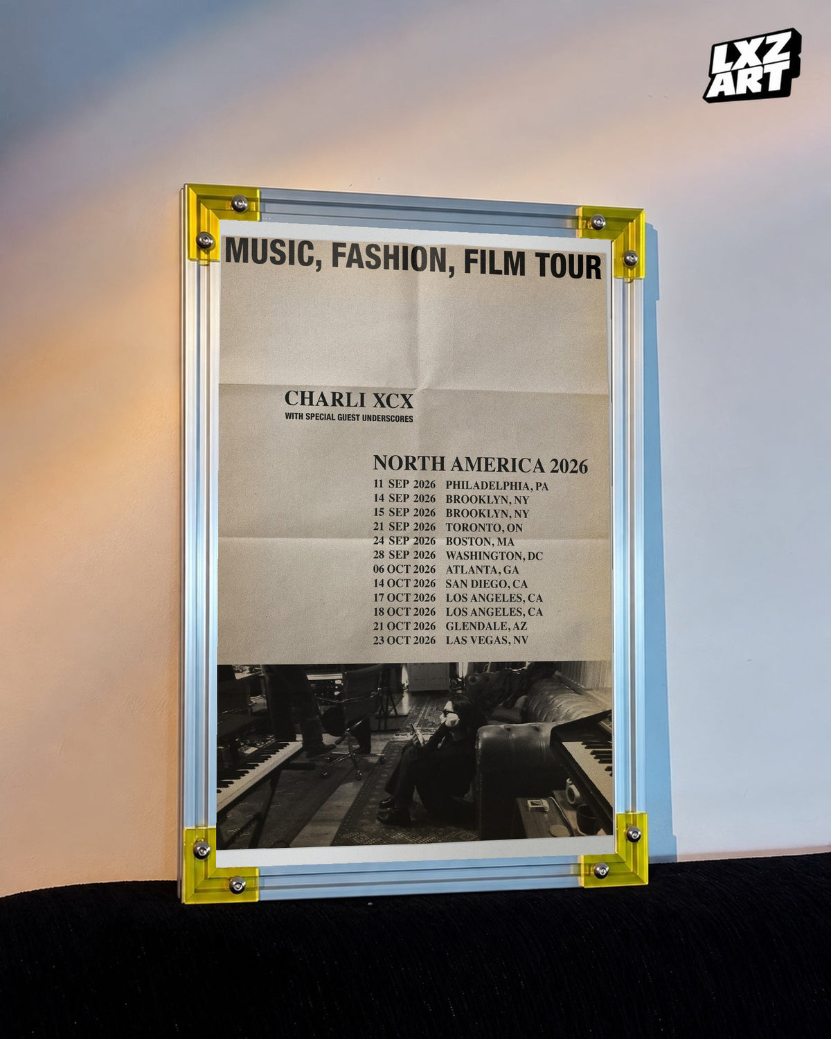 Charli xcx Music Fashion Film 2026 Tour Poster with the complete tour heading displayed on a warm wall in a yellow corner frame; frame not included
