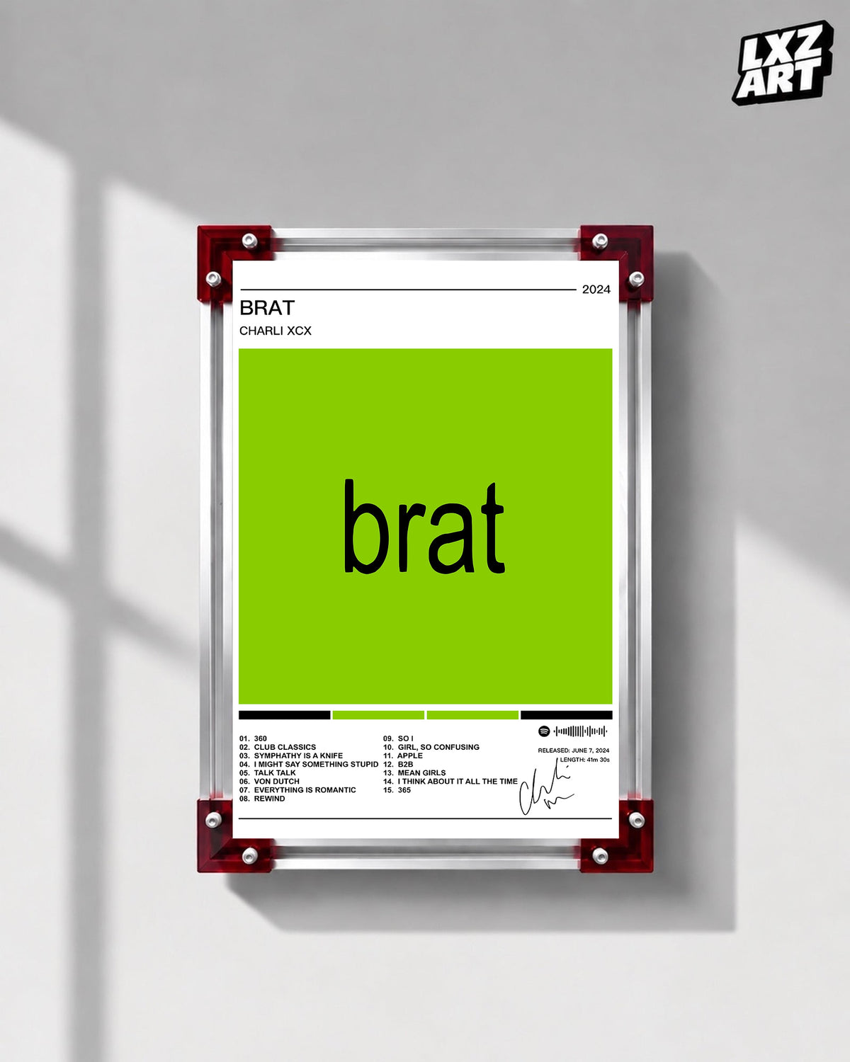 Charli xcx Brat White Tracklist Poster displayed on a gray wall in a red corner frame; unframed print, frame not included