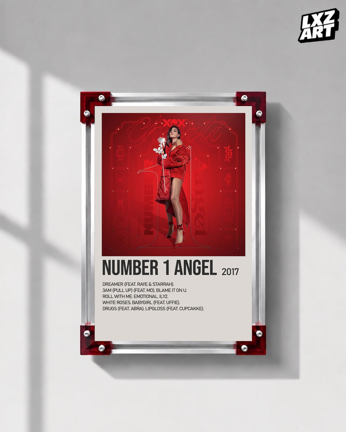 Charli xcx Number 1 Angel Red Tracklist poster displayed in the red corner frame on a gray wall; frame not included