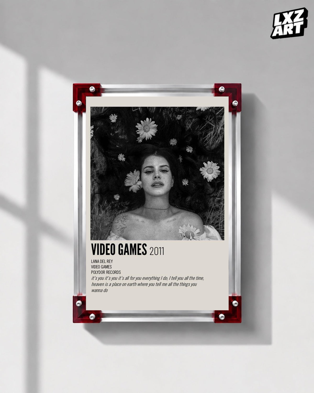 Lana Del Rey Video Games Monochrome Floral Portrait Poster displayed on a gray wall in a red corner frame; unframed print, frame not included
