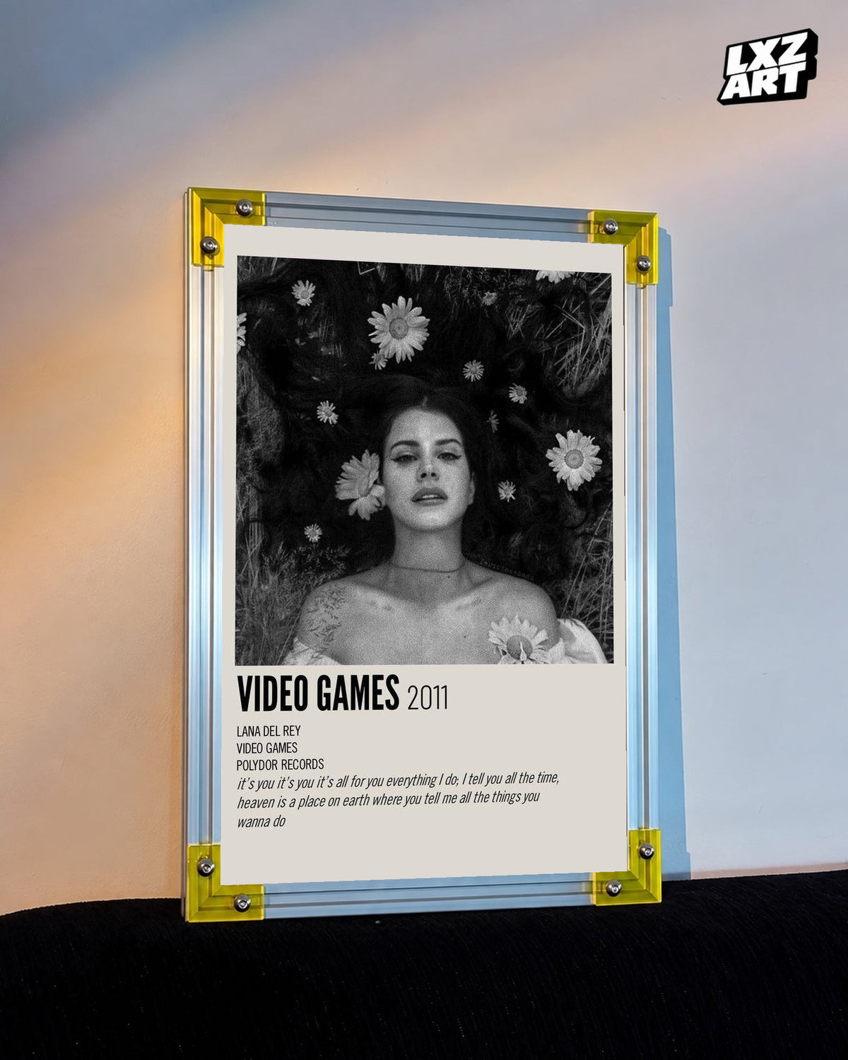 Lana Del Rey Video Games Monochrome Floral Portrait Poster displayed on a warm wall in a yellow corner frame; unframed print, frame not included