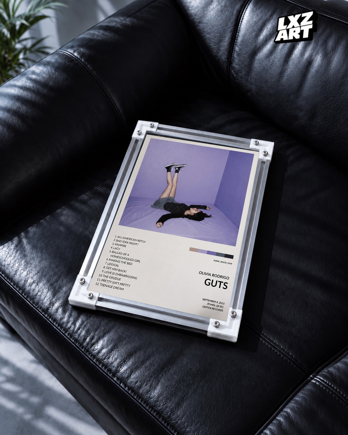 Olivia Rodrigo GUTS Tracklist Poster — black leather sofa; frame for display only