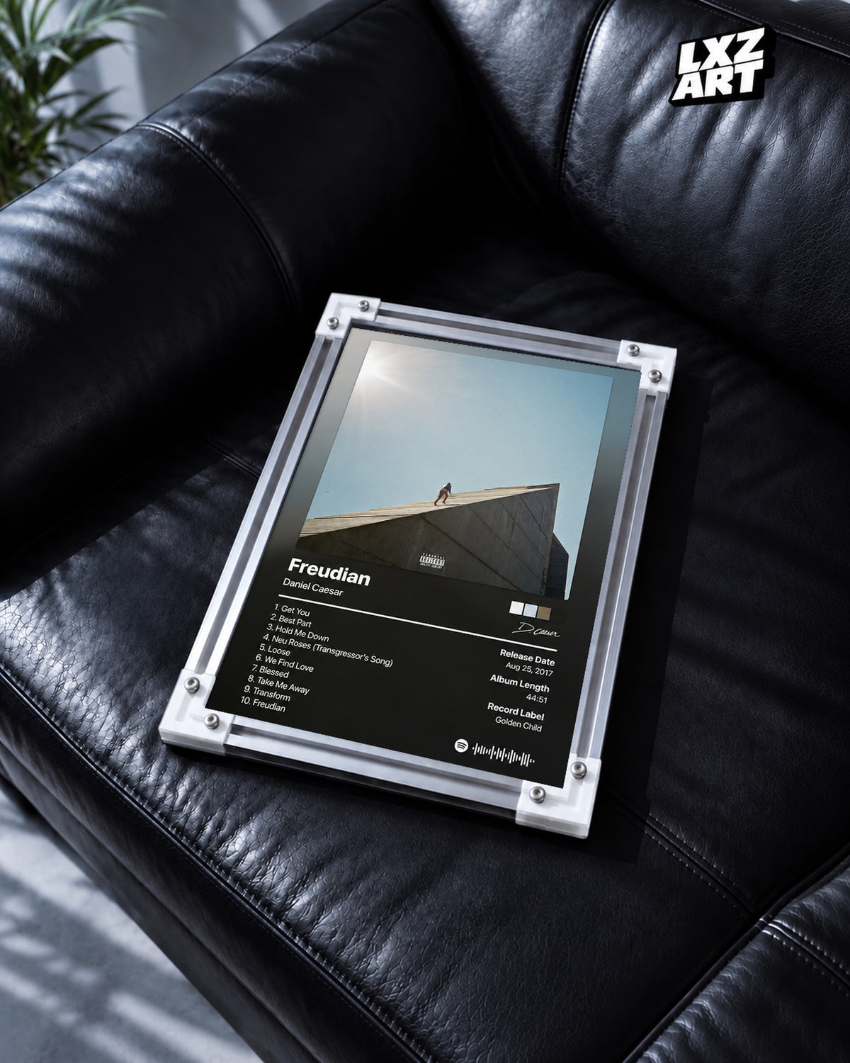 Daniel Caesar Freudian Tracklist Poster — black leather sofa; frame for display only